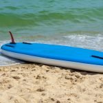 Inflatable standup paddleboard iSUP upside down on the beach